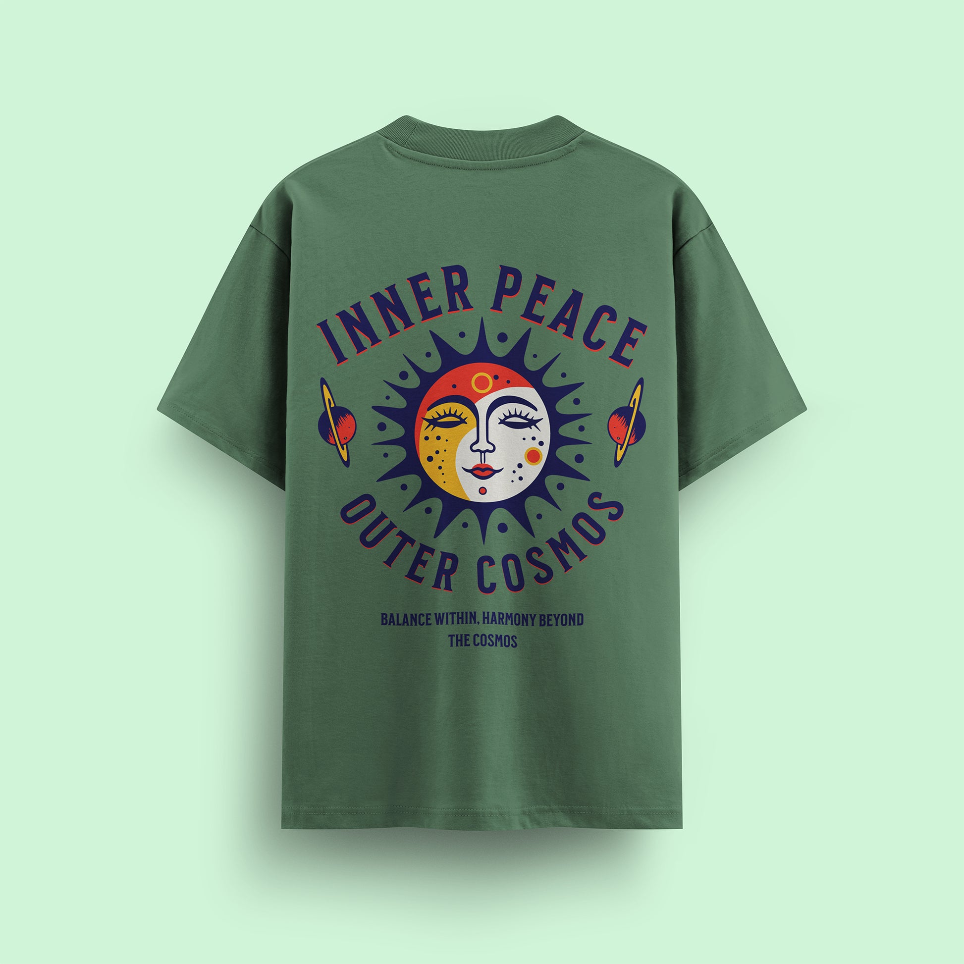Green t-shirt with 'Inner Peace Outer Cosmos' design on a light green background