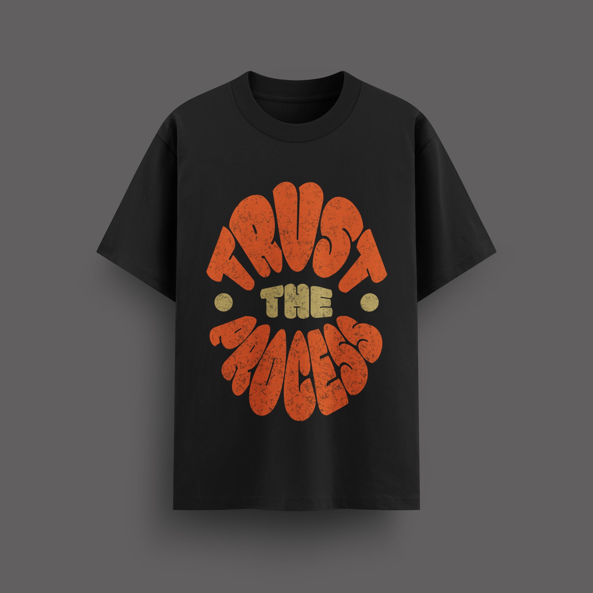Black t-shirt with 'Trust the Process' text design on a dark background