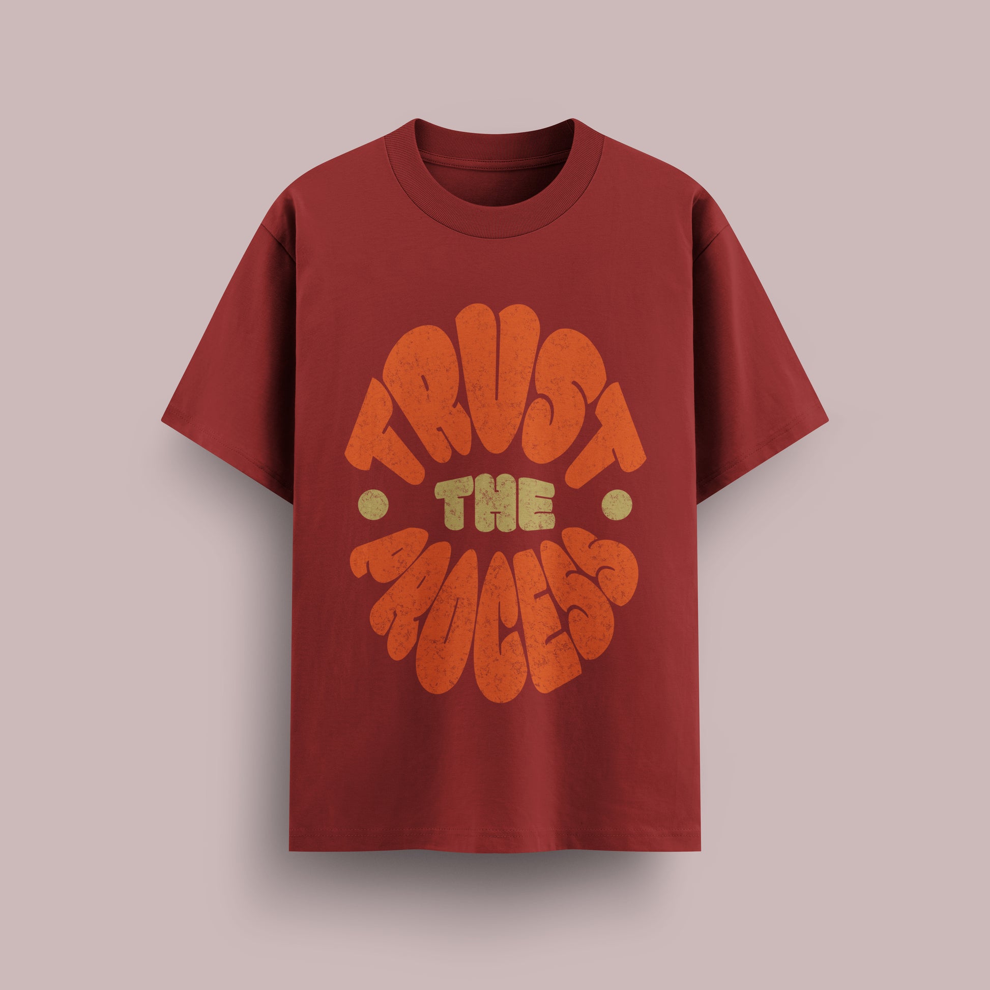 Red t-shirt with 'Trust The Process' text on a beige background