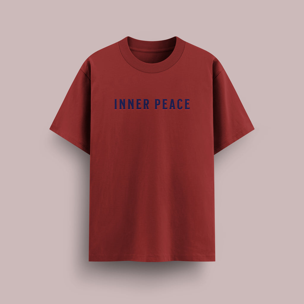 Red t-shirt with 'INNER PEACE' text on a beige background