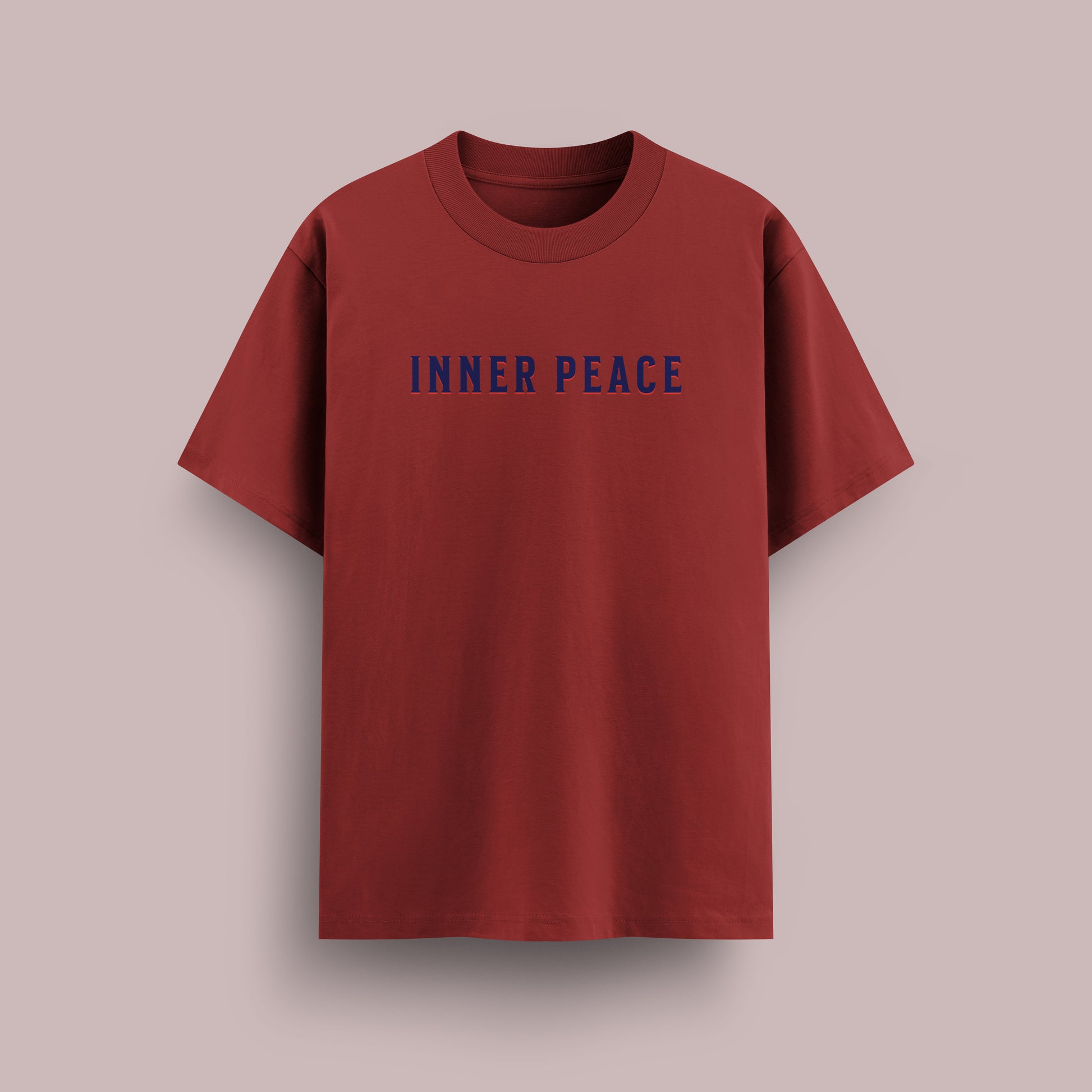 Red t-shirt with 'INNER PEACE' text on a beige background