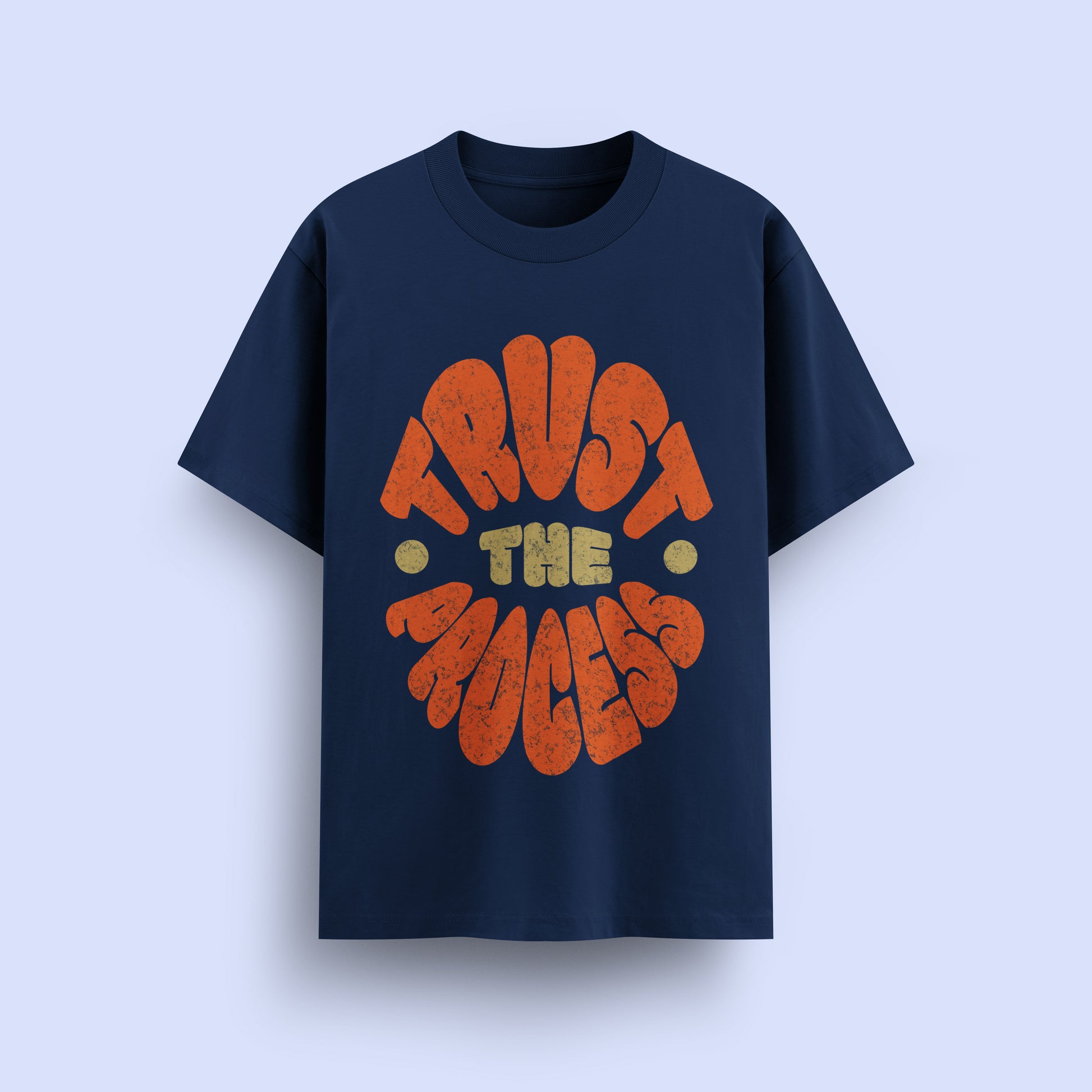 Navy blue t-shirt with 'Trust The Process' text in orange and yellow on a light purple background