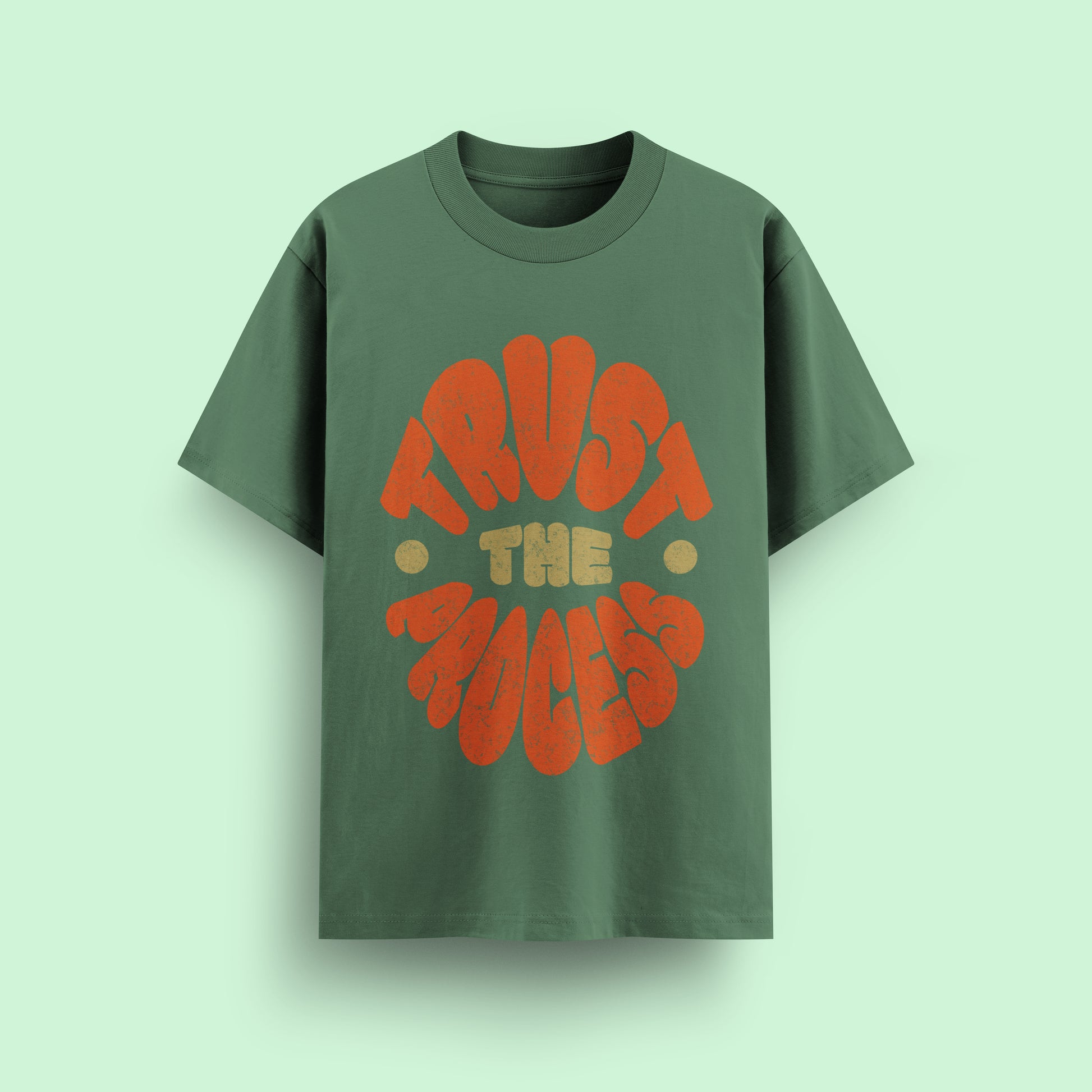 Green t-shirt with 'Trust The Process' text on a light green background