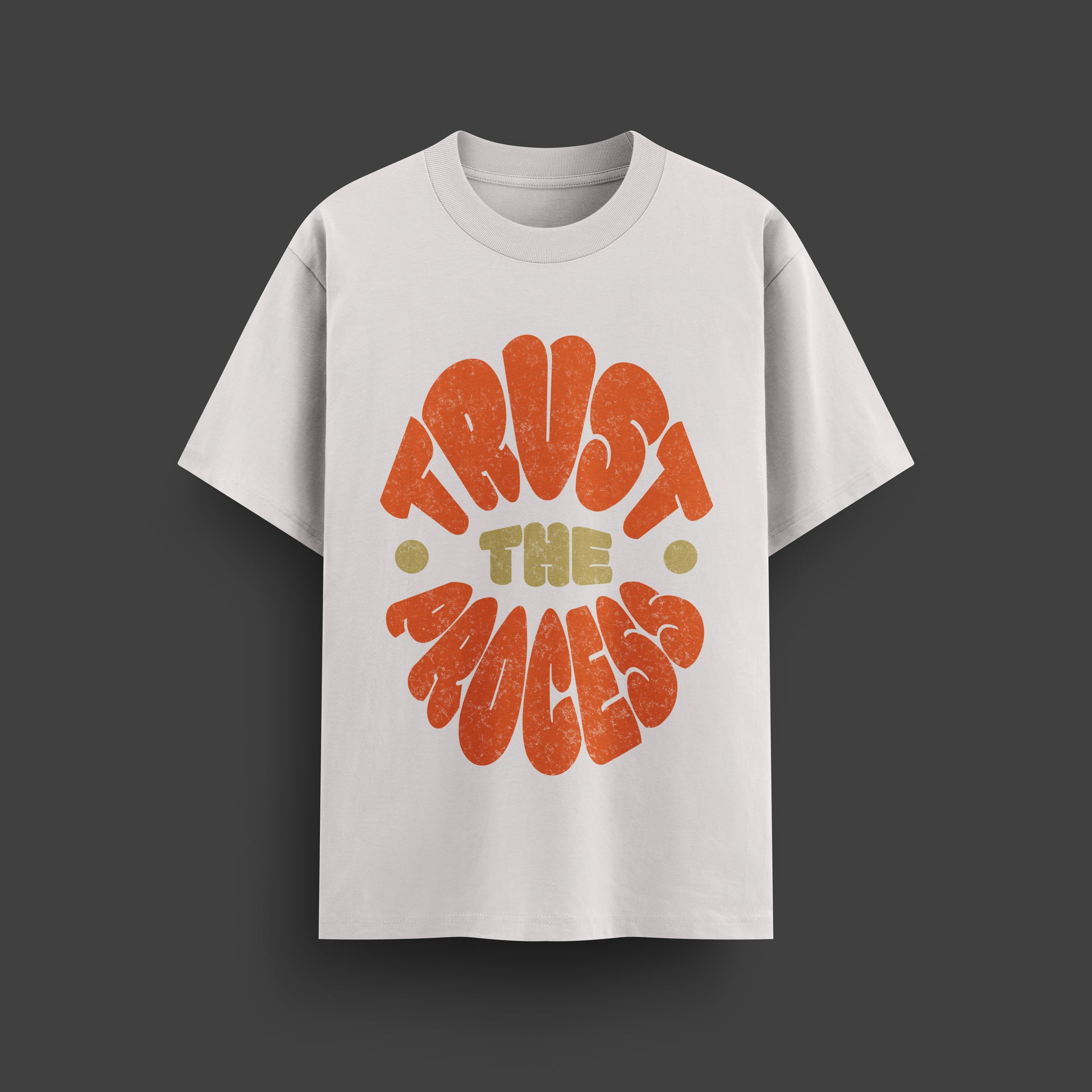 White t-shirt with 'Trust the Process' text in orange and yellow on a dark gray background