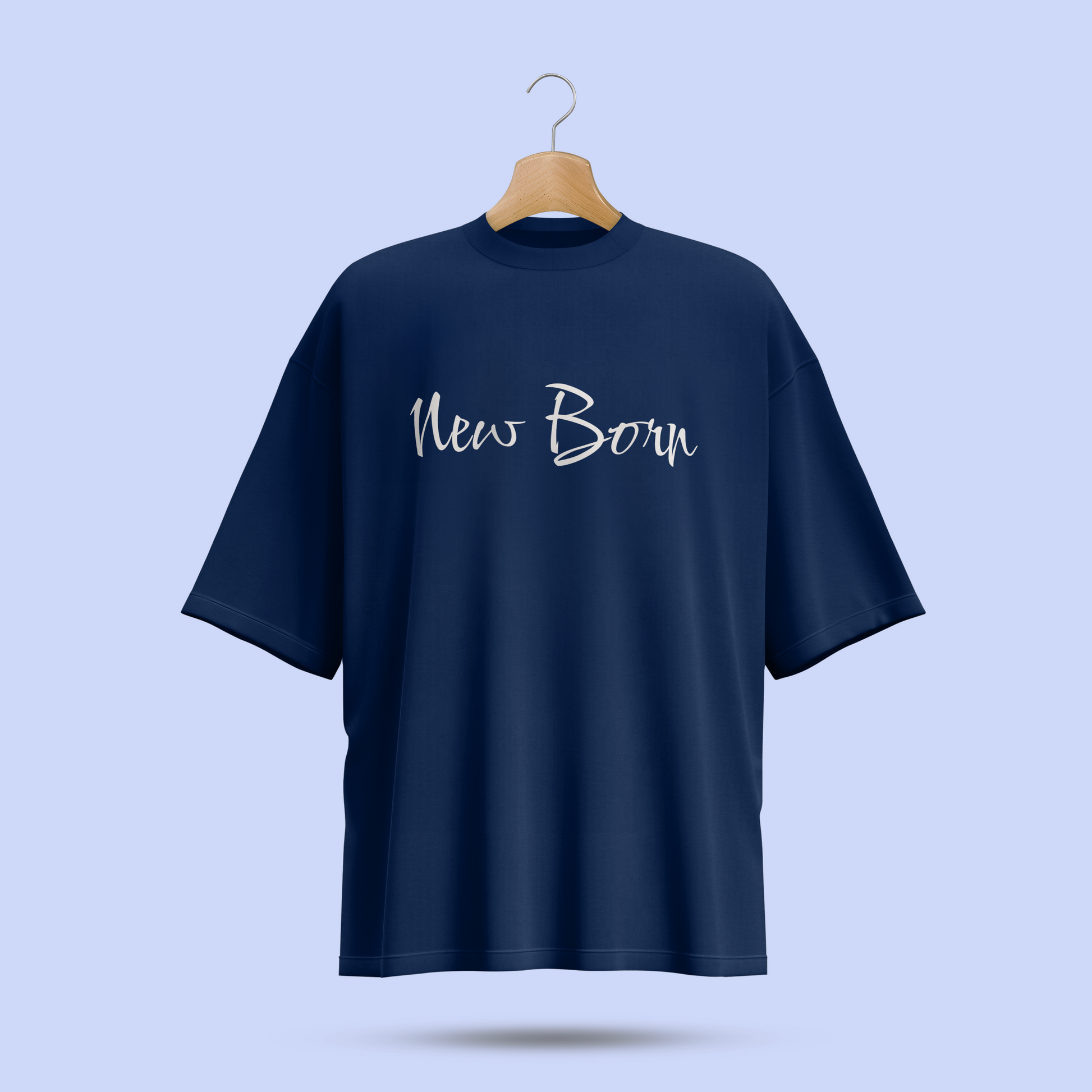 Navy blue oversize t-shirt with 'New Born' text on a hanger against a light blue background