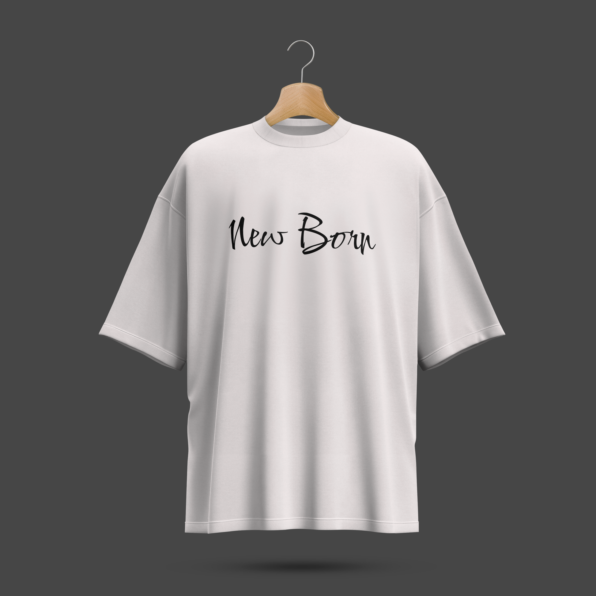 White oversize t-shirt with 'New Born' text on a hanger against a dark background